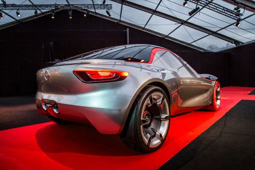Free Modern sports car displayed on a red carpet at an indoor auto exhibition showcasing its sleek design. Stock Photo