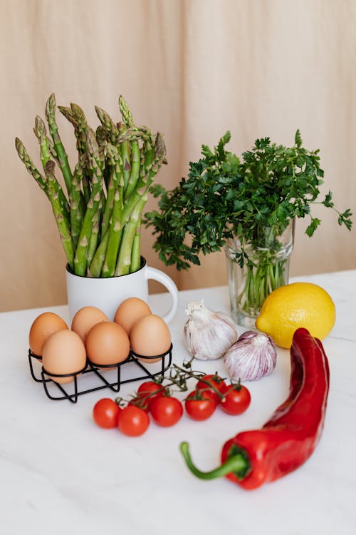 Set of fresh vegetables and eggs on table