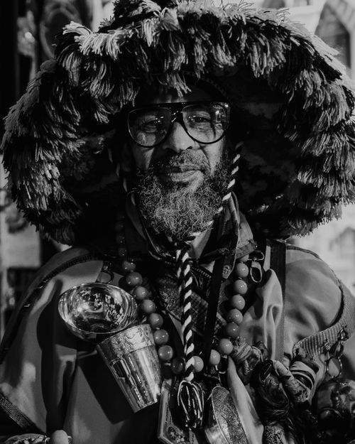 Free A black and white portrait of a traditional water seller in Fes, Morocco, wearing cultural attire. Stock Photo