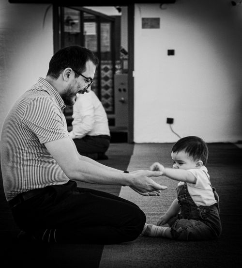 Free A touching black and white scene of a father playing with his toddler indoors. Stock Photo