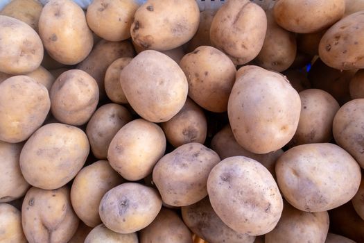 A close-up shot of fresh potatoes at a market in İzmir, highlighting texture and quality.