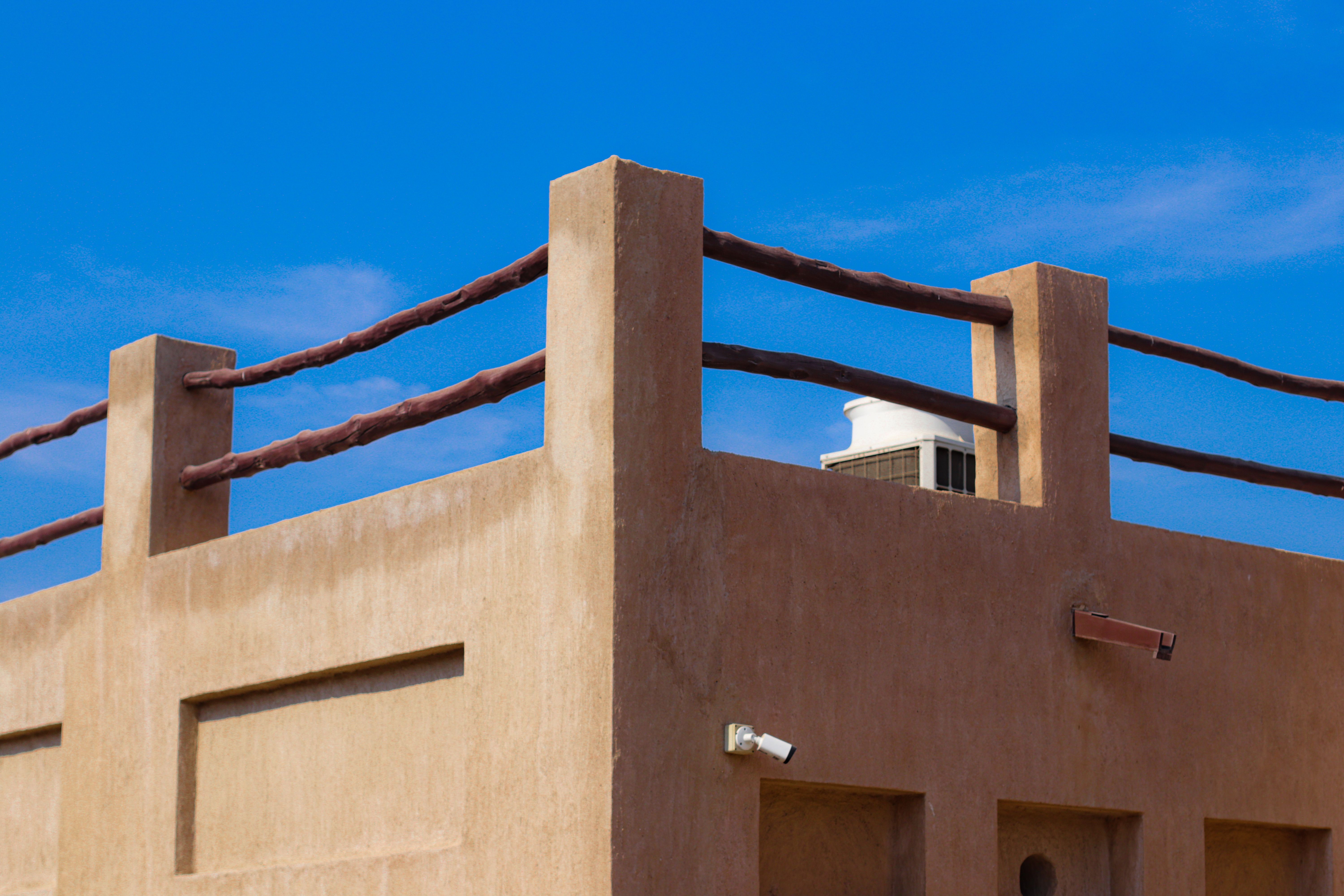 Adobe Building with Clear Blue Sky Backdrop · Free Stock Photo