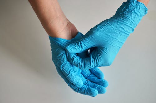 Person Wearing Surgical Gloves
