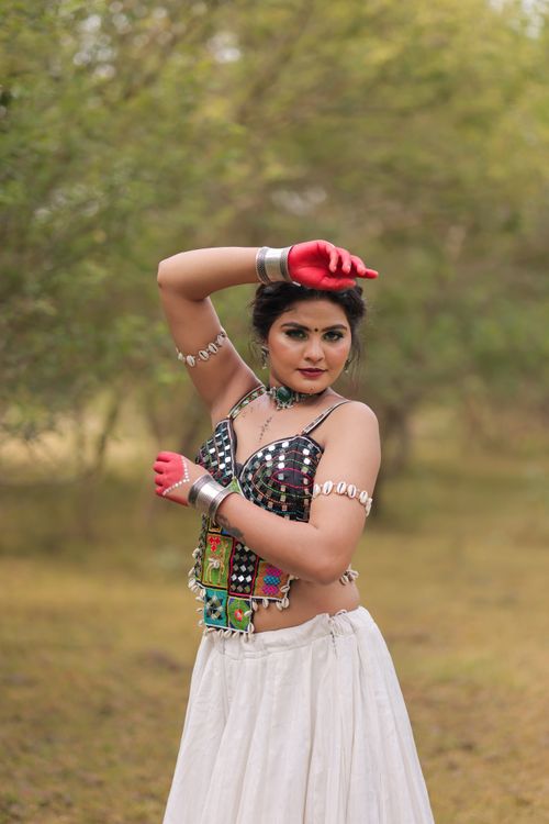 Free Young woman performing traditional dance in colorful attire outdoors. Stock Photo