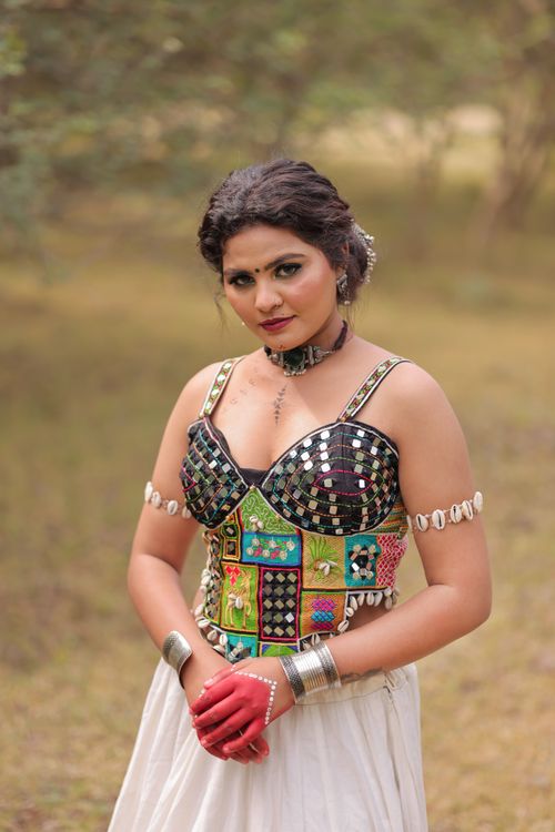 Free Elegant woman in traditional patchwork dress posing outdoors, expressing cultural heritage. Stock Photo