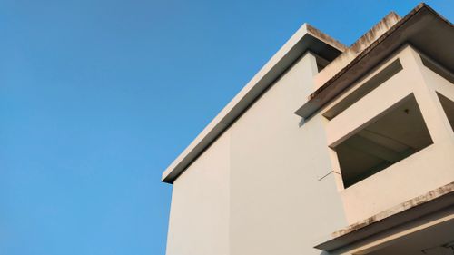 Free Contemporary architectural detail with clean lines against a clear blue sky. Stock Photo