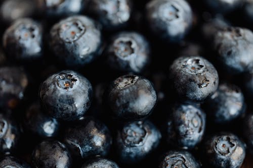 Closeup of yummy raw and fresh blueberries placed on supermarket counter