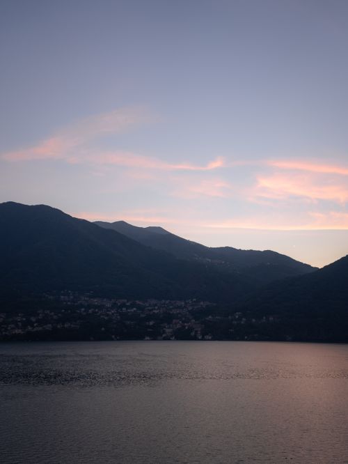 Free Peaceful sunset over Lake Como with mountain silhouette and pastel sky in Lombardei, Italy. Stock Photo