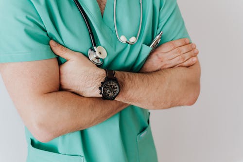Free Unrecognizable crop man in wristwatch with stethoscope Stock Photo