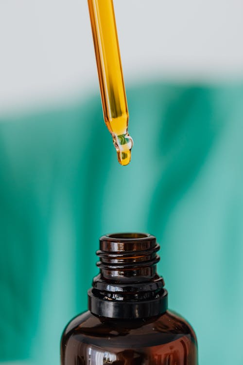 Brown glass bottle with liquid and pipette