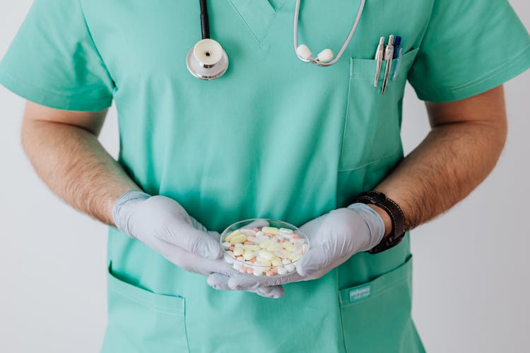 Crop Man Doctor With Stethoscope And Medicine