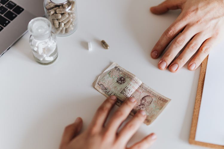 Patient Giving Banknote For Pills In Hospital