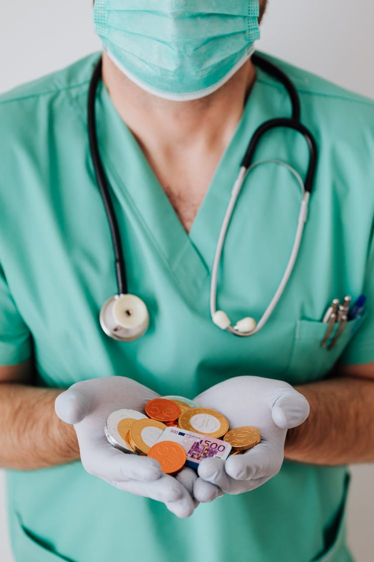 Unrecognizable Male Doctor With Money