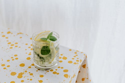 Glass of fresh cocktail on table