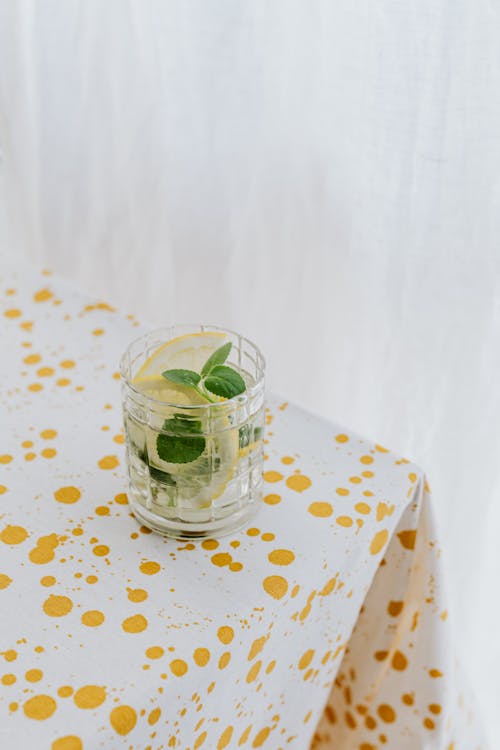 Free From above of crystal glass of refreshing cold drink garnished with mint placed on table Stock Photo