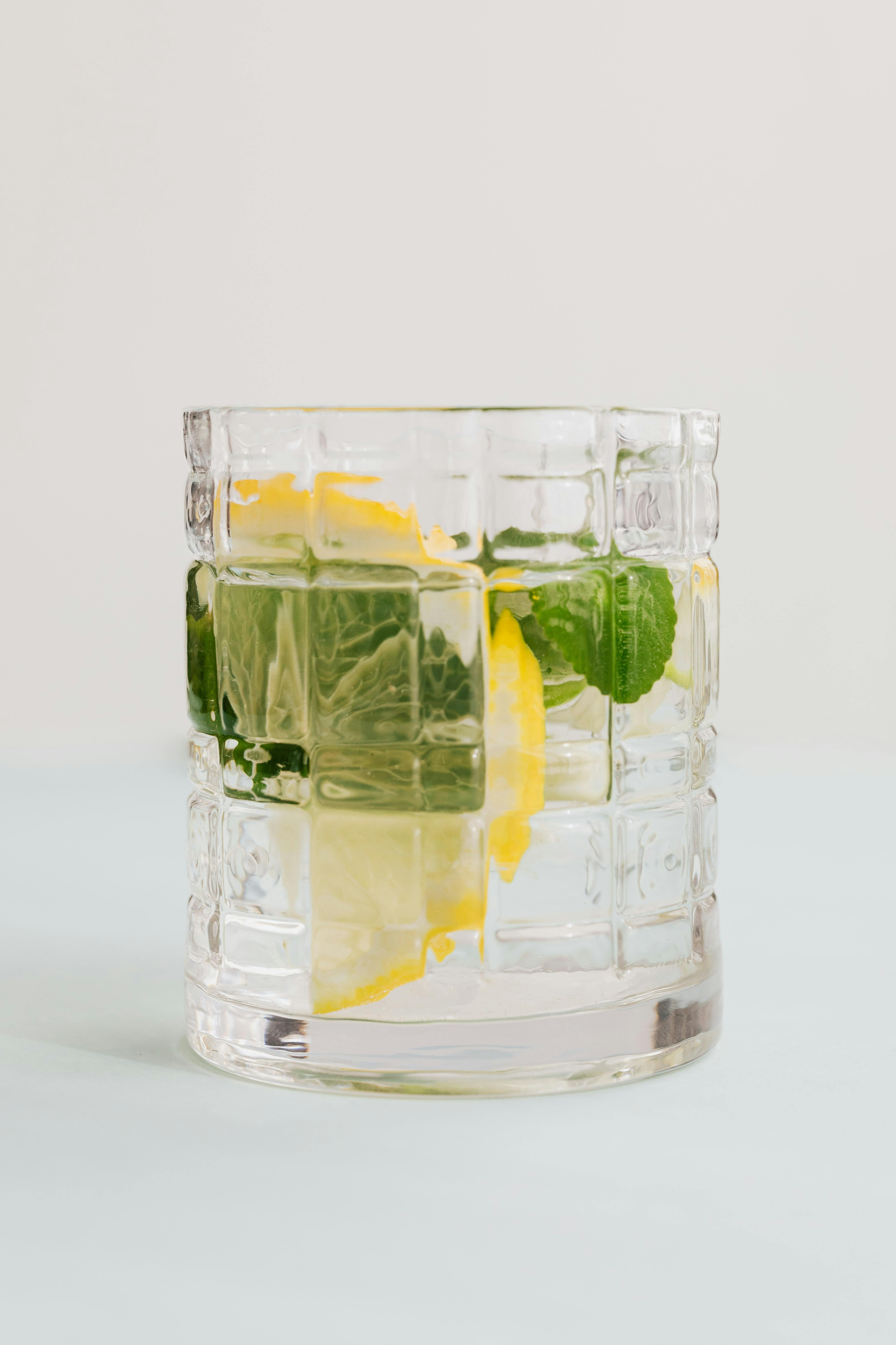 Glass of mojito with lemon and mint on white background · Free Stock Photo
