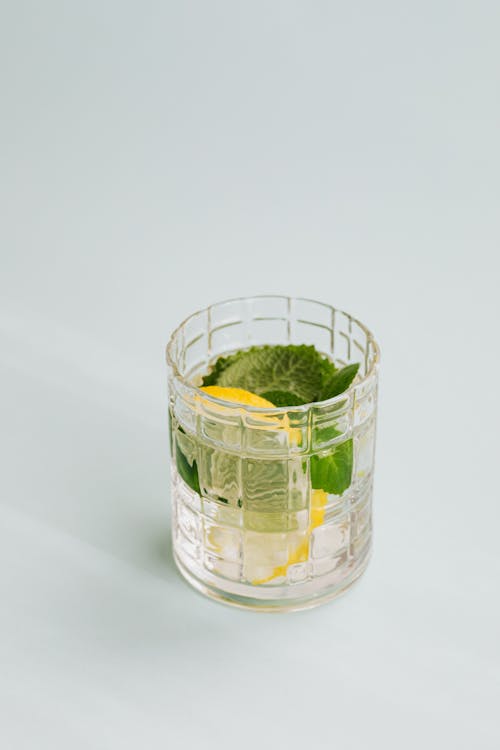 Free Flat lay of refreshing mojito drink made of mint and lemon placed on white background Stock Photo