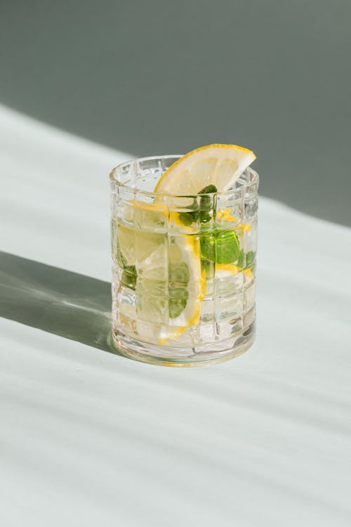 Glass of fresh drink on white background