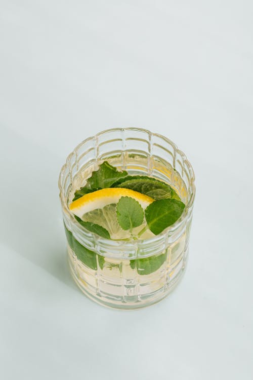 Glass of cocktail on white background