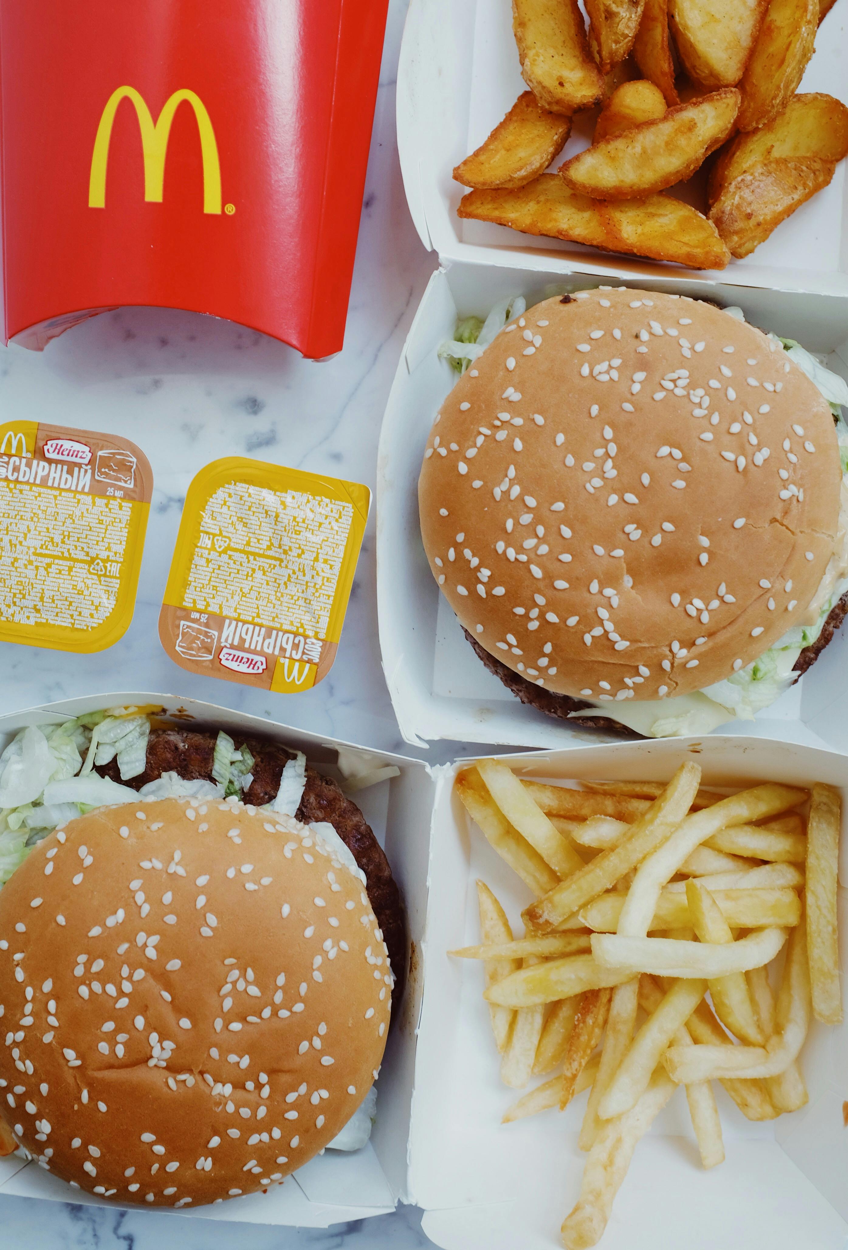 Seasoned snack plate with vegetables and dips on a wooden board