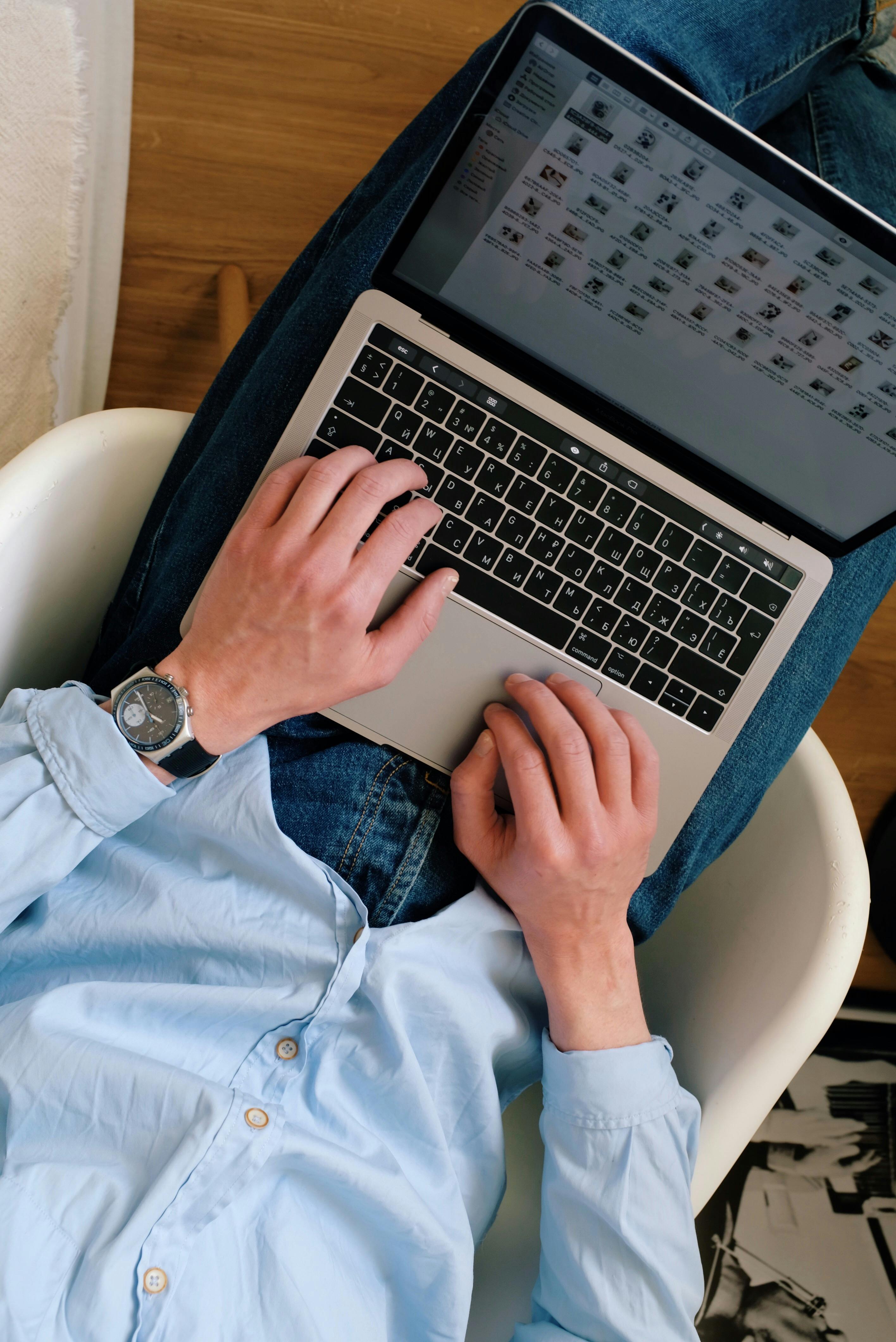 Unrecognizable man working on laptop remotely \u00b7 Free Stock Photo