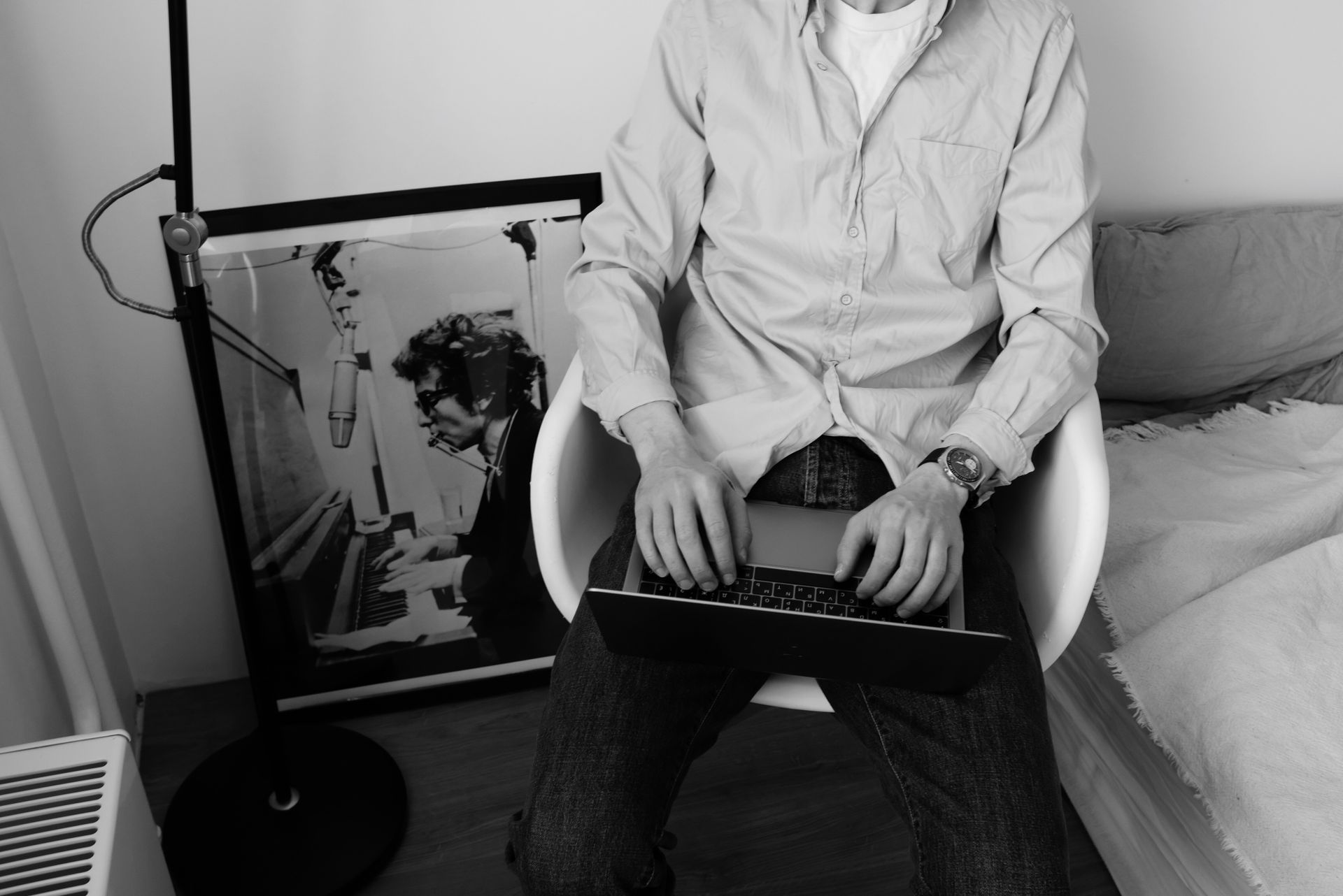 Unrecognizable male employee in casual wear sitting on chair and surfing internet on laptop while working on business project remotely