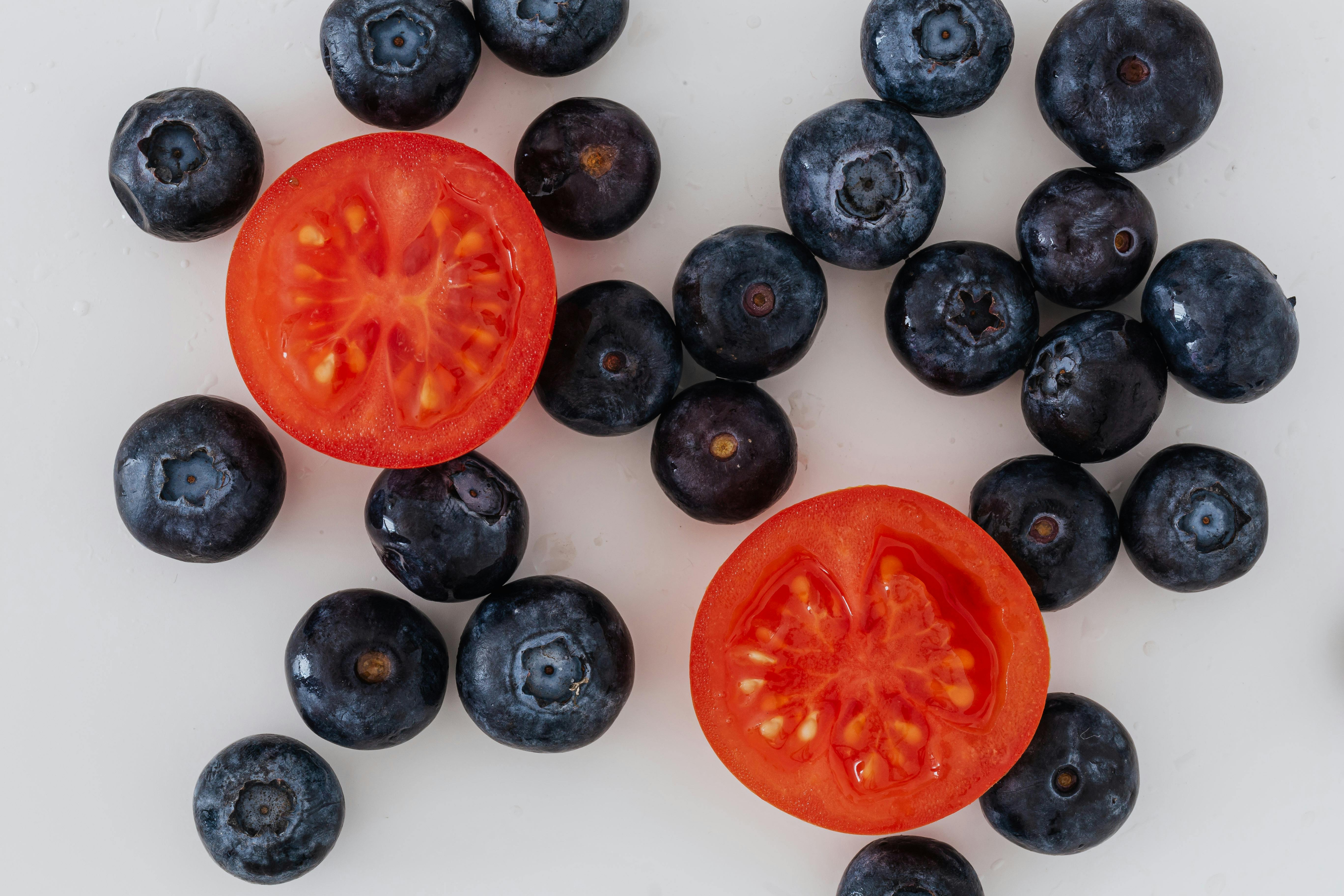 halves of tomato and scattered blueberries