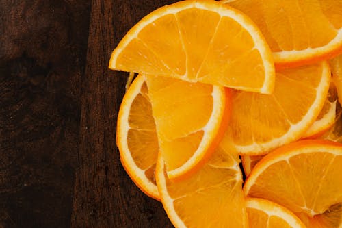 Top view slices of fresh oranges on wooden background