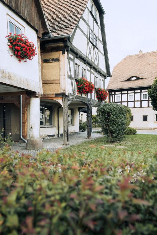 Free Picturesque half-timbered houses surrounded by greenery in Zittau, displaying classic Saxon architecture. Stock Photo