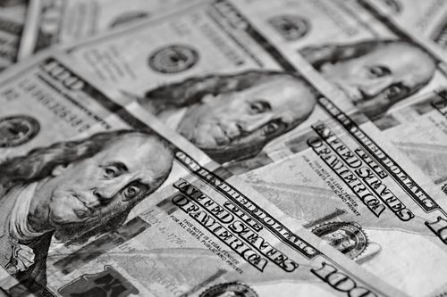 Free A detailed black and white image of multiple US dollar bills focusing on Benjamin Franklin's portrait. Stock Photo