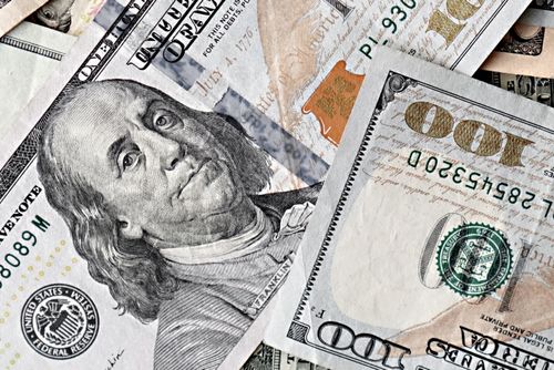 Free Detailed close-up of multiple US one hundred dollar bills in a scattered arrangement. Stock Photo