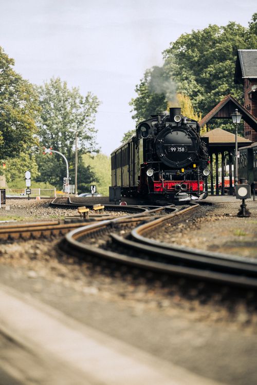 Free A scenic view of a steam train arriving at Zittau station on a clear day. Stock Photo