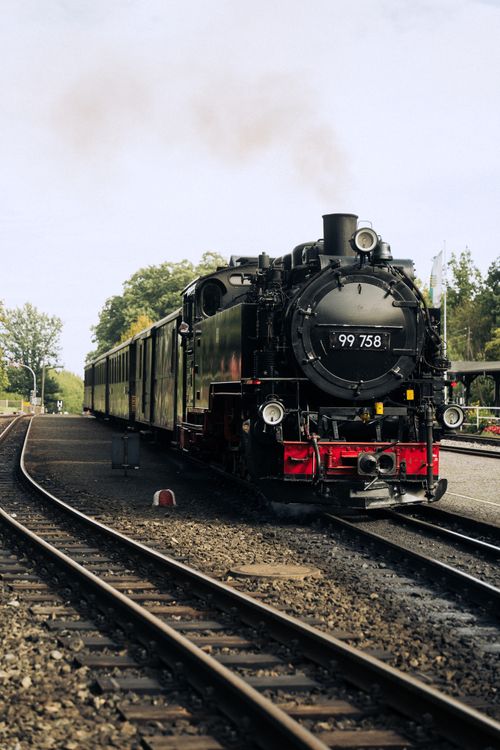 Free A vintage steam locomotive with passenger carriages waits at Zittau station in Saxony, Germany. Stock Photo