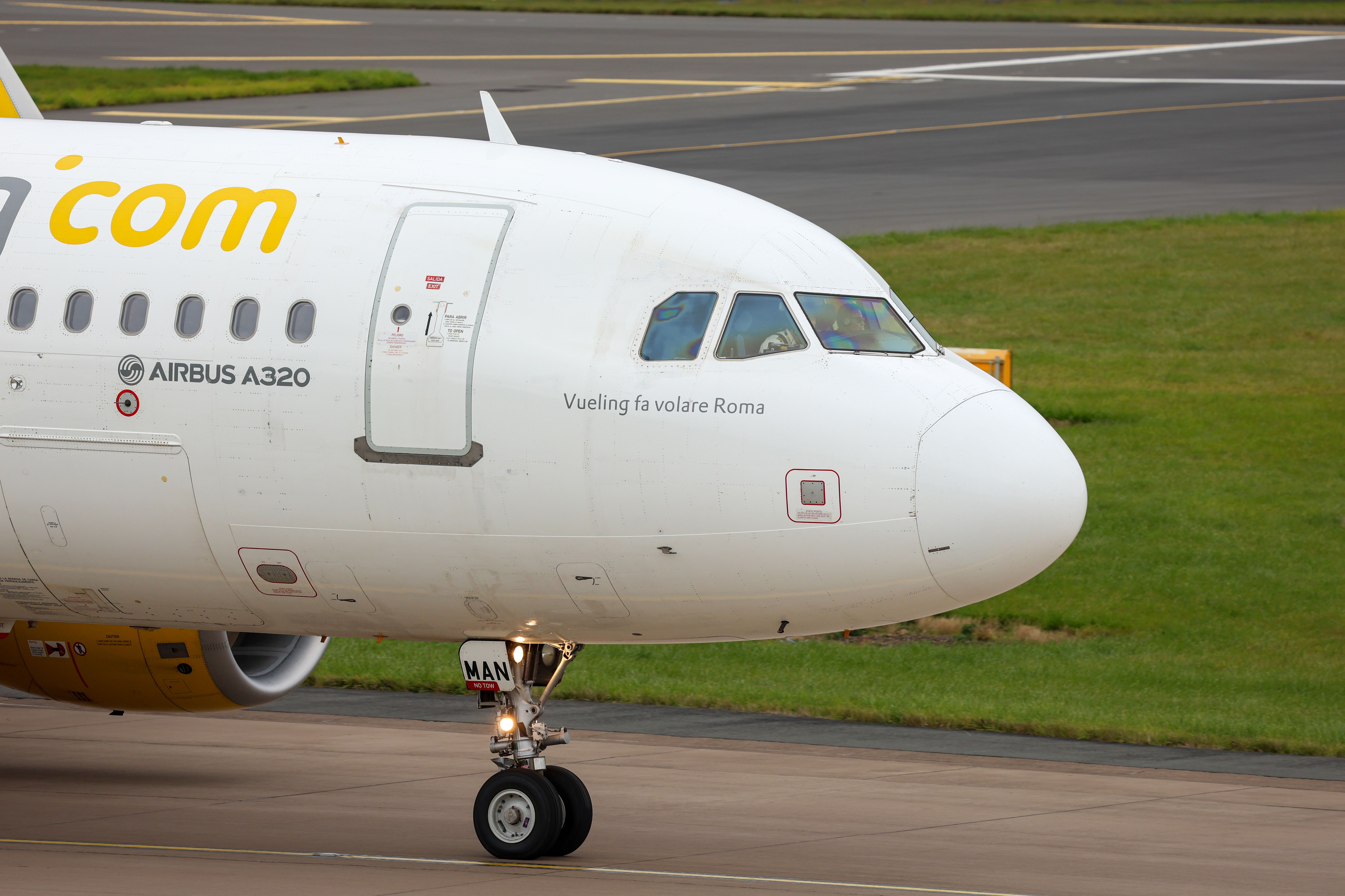 Airbus A320 taxiing on a runway in Scotland, showcasing modern aviation technology.