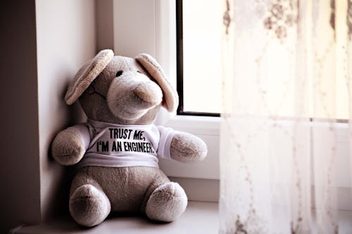 Free Brown Teddy Bear By The Window Stock Photo