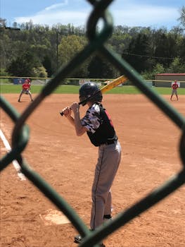 A young athlete ready to hit during a baseball game on a sunny day in Knoxville.