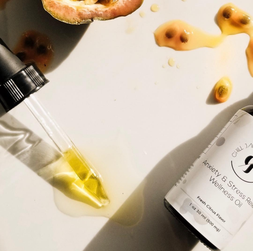 Free Overhead view of wellness oil dropper with spilled passionfruit seeds on surface, depicting a natural, holistic lifestyle. Stock Photo