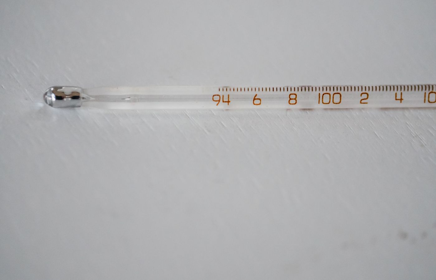 Detailed image of a glass thermometer displaying temperature in degrees.