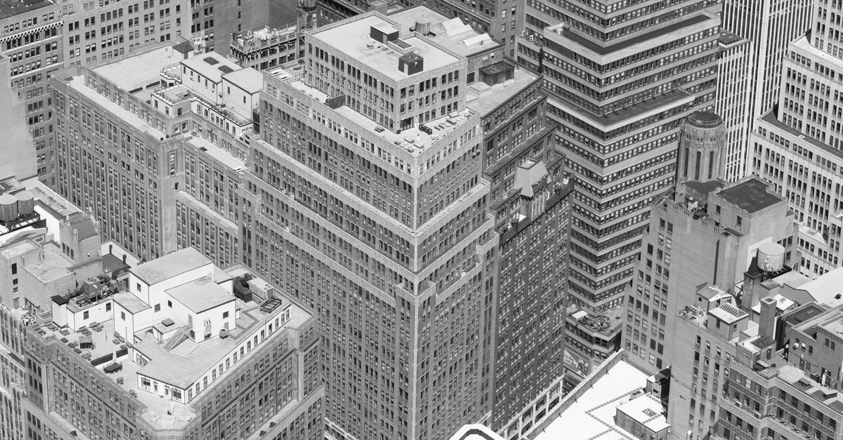 Black and white aerial view of New York City skyscrapers showcasing urban architecture.