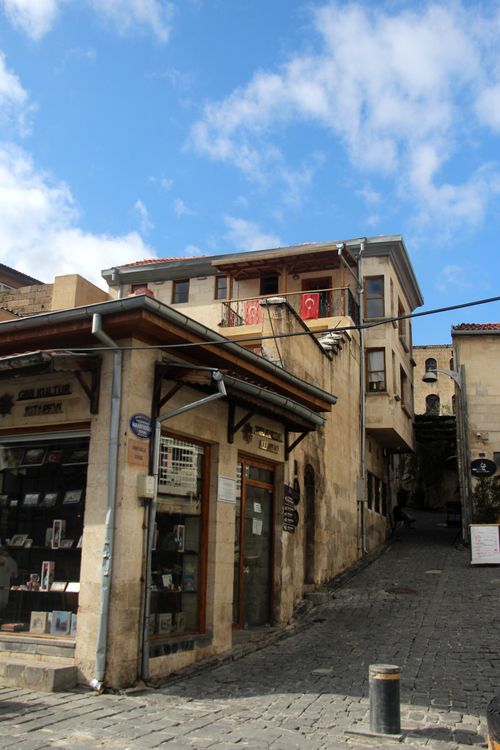 Free A picturesque street in Gaziantep's old town, showcasing traditional architecture under a bright blue sky. Stock Photo