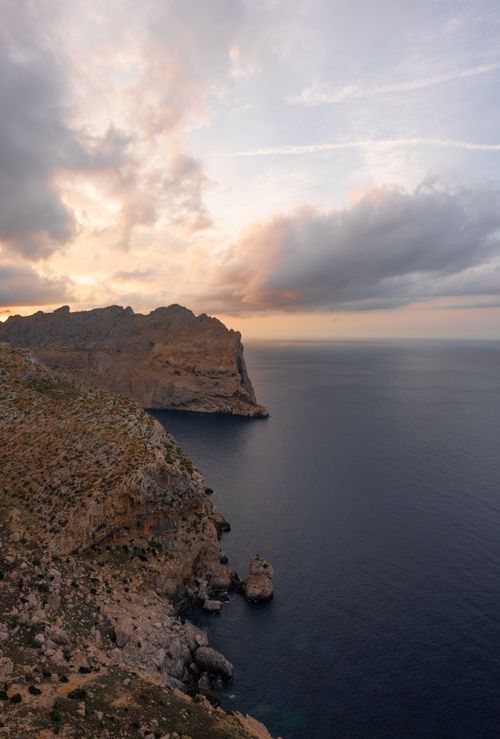 Free Dramatic view of rugged coastal cliffs overlooking the serene sea at sunset in IB, Spain. Stock Photo