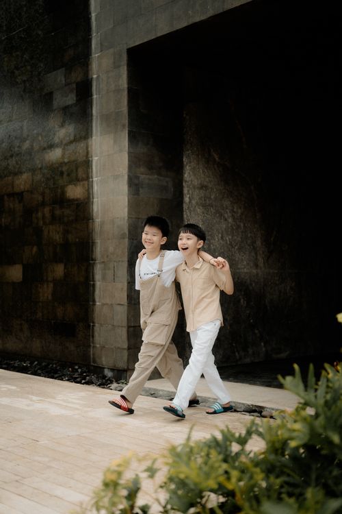Free Two cheerful children walking together, showcasing friendship and happiness in an outdoor setting in Bali. Stock Photo