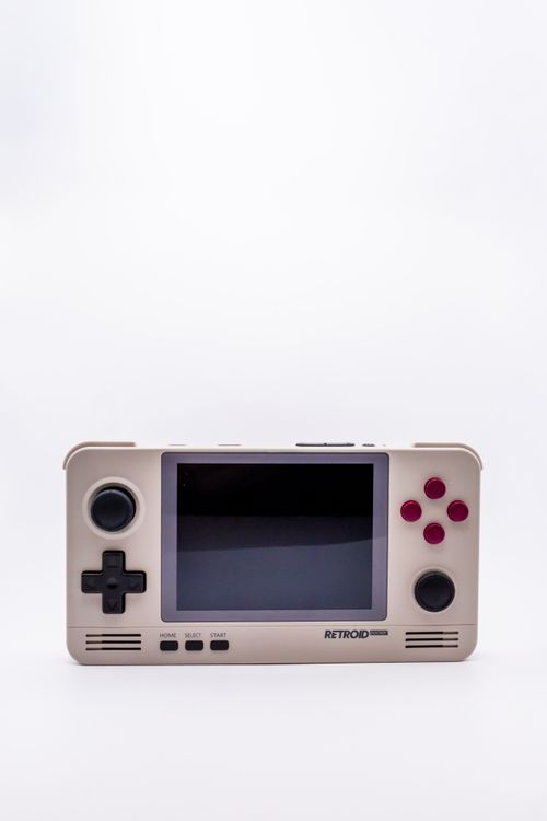 Free Minimalist shot of a retro handheld gaming console with a white background, showcasing vintage design. Stock Photo