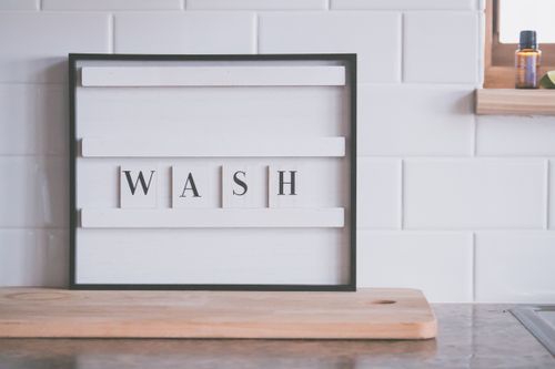 Free Letters forming word WASH arranged on board on bathroom counter representing hygiene and coronavirus prevention concept Stock Photo