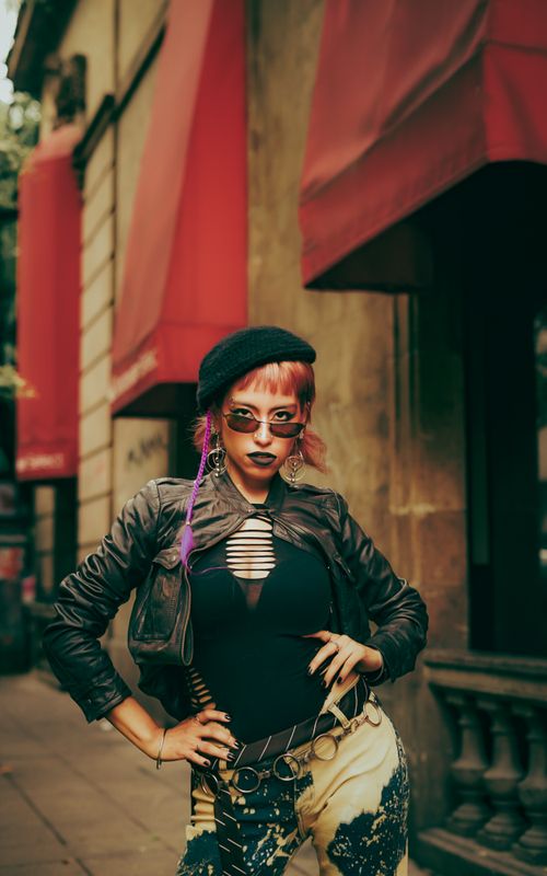 Free Portrait of a woman with edgy fashion in an urban setting, showcasing bold style and attitude. Stock Photo