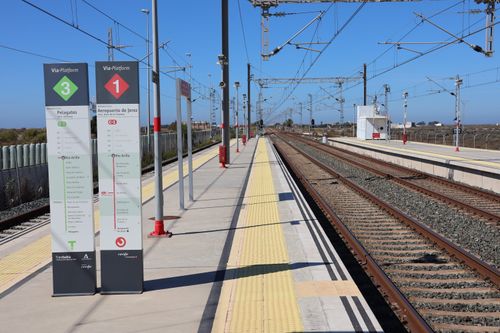 Free Wide view of the railway tracks and platforms at San Fernando train station in Spain under a clear blue sky. Stock Photo
