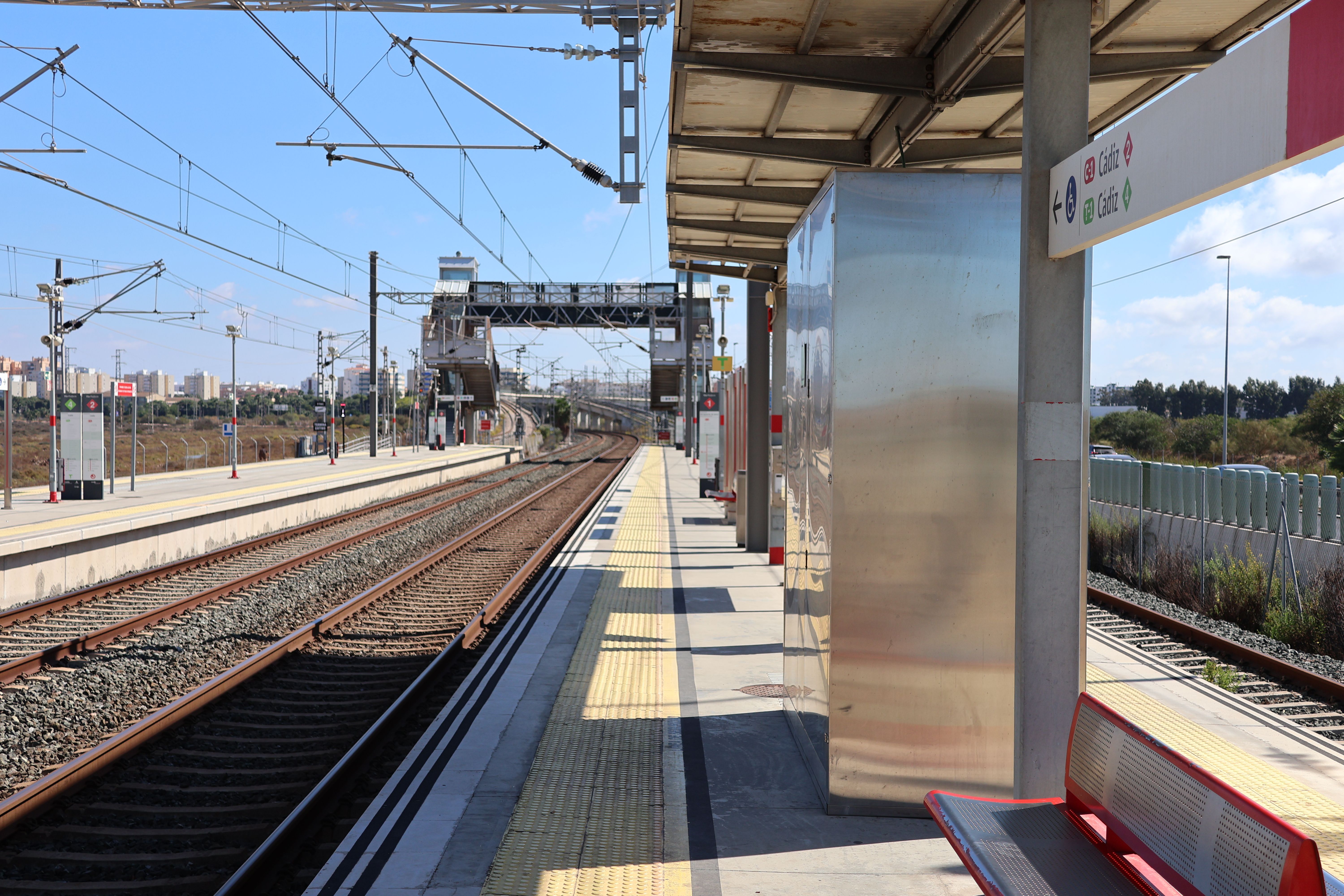 Empty railway platform at San Fernando station on a sunny day in Spain.