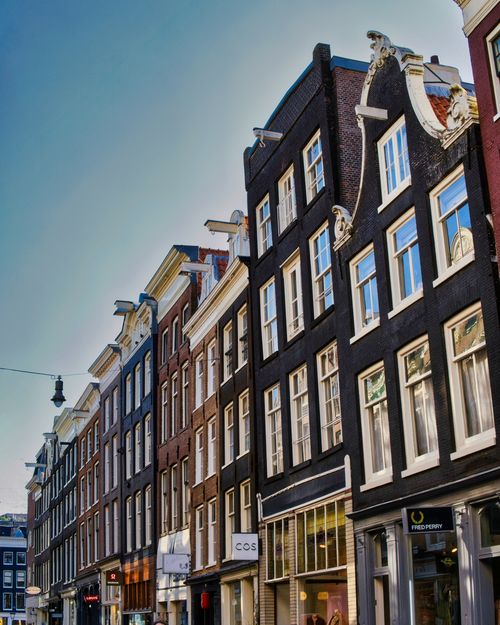 Free Classic Dutch architecture of canal houses in the heart of Amsterdam, Netherlands. Stock Photo