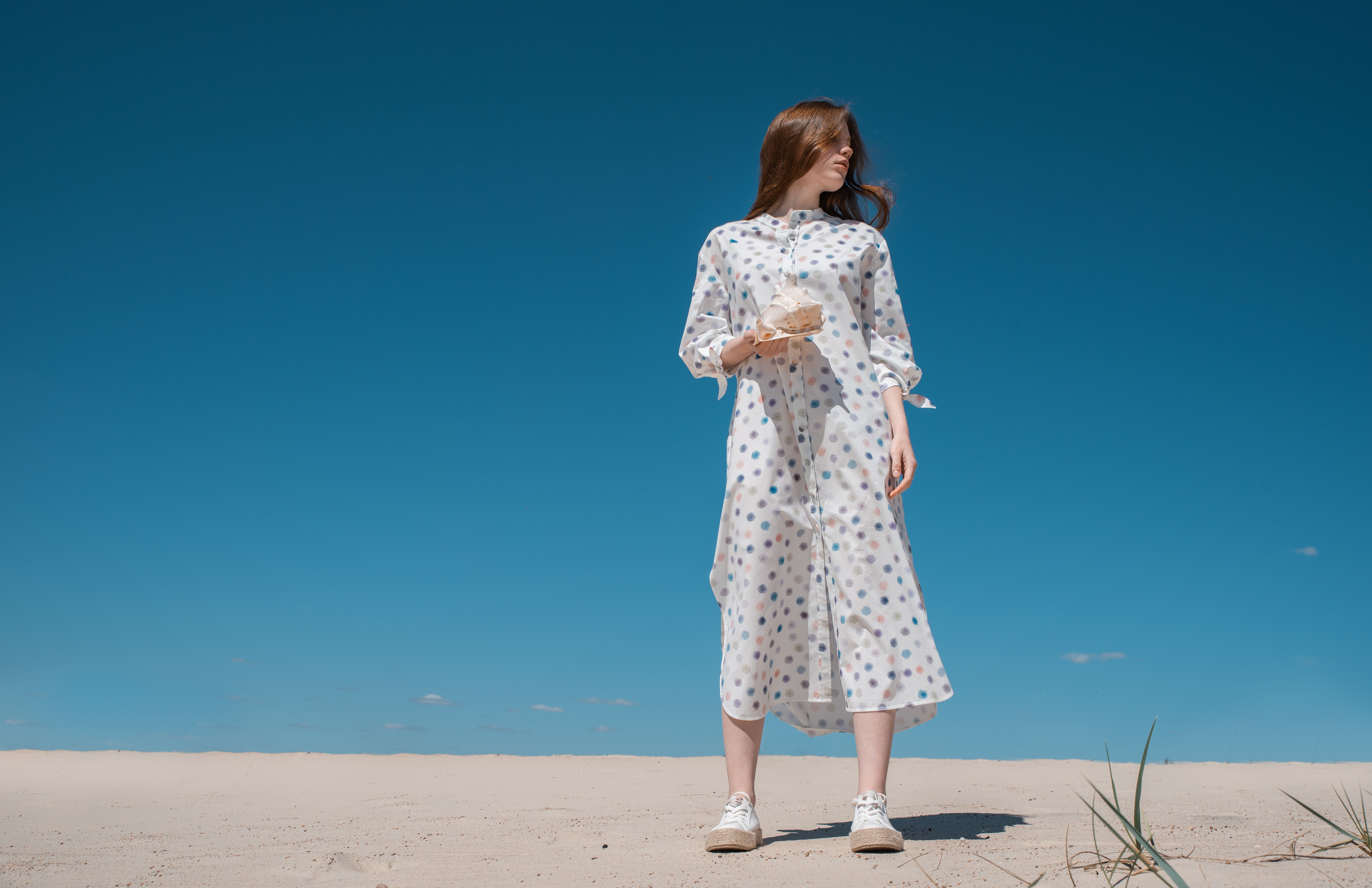 Woman Standing on Sandy Beach with Clear Blue Sky · Free Stock Photo