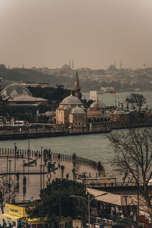 Free A serene aerial view of Istanbul's historic harbor showcasing a beautiful mosque by the water. Stock Photo